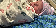 Slayd is registered to the contest to win money with this photo: baby, bed, blanket, blue, cute, face, footprints, hat, healthcare, hospital, infant, newborn, pattern, person, pink, resting, sleeping, soft, striped, swaddled