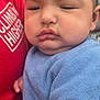 Aurelius joined the competition — help win amazing prizes! baby, child, face, cheeks, blue_bib, red_shirt, hand, person, portrait, outdoor, urban, building, skin, expression, holding, closeup, young, cute, infant, sleepy