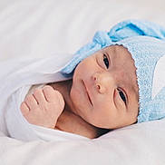 Hudson joined the competition — help win amazing prizes! newborn, baby, infant, wrapped, blanket, blue_hat, knitted_hat, crescent_moon, face, cute, sleeping_area, soft, closeup, portrait, skin, hand, fist, lying_down, bed, cozy