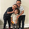 children, kids, siblings, group_portrait, smiling, peace_sign, eyeglasses, indoor, portrait, standing, friendship, family, casual_clothing, colorful_sneakers, hardwood_floor, wall, playful, happy, young_people, photography