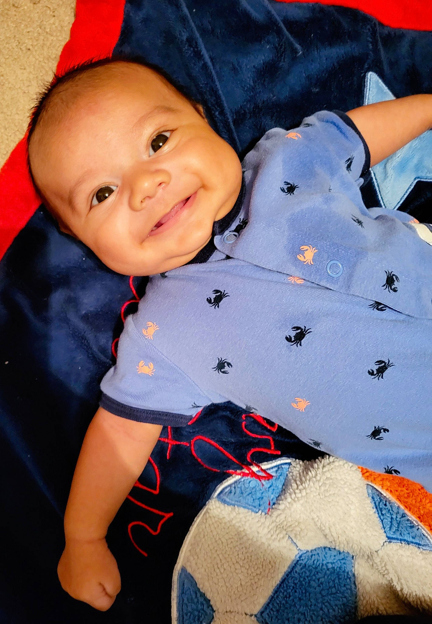 Alonso is registered to the contest to win money with this photo: baby, baby_toddler_clothing, carmine, cheek, child, comfort, electric_blue, eye, fun, happy, joy, orange, pattern, person, red, skin, sleeve, smile, t_shirt, textile