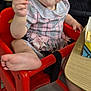 Lyanna is registered to the contest to win money with this photo: toddler, child, high_chair, french_fry, pink_dress, bow, foot, table, box, indoor, restaurant, person, food, seat, plaid, curly_hair, expression, hand, casual, floor