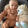 baby, infant, onesie, brown_clothing, teddy_bear, plush_toy, baby_seat, child, cute, snuggling, soft_toy, face, person, indoor, comfort, seatbelt, closeup, portrait, baby_fashion, adorable