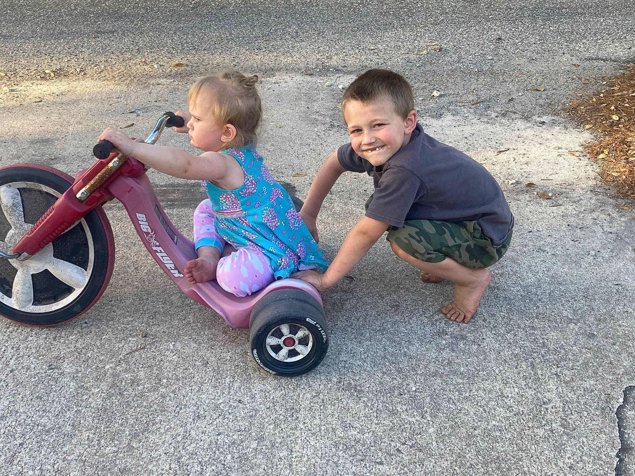 Aiden is registered to the contest to win money with this photo: automotive_tire, automotive_wheel_system, bicycle, bicycle_tire, bicycle_wheel, fun, grass, happy, joy, land_vehicle, leisure, motor_vehicle, person, riding_toy, rolling, smile, synthetic_rubber, tire, toddler, tread