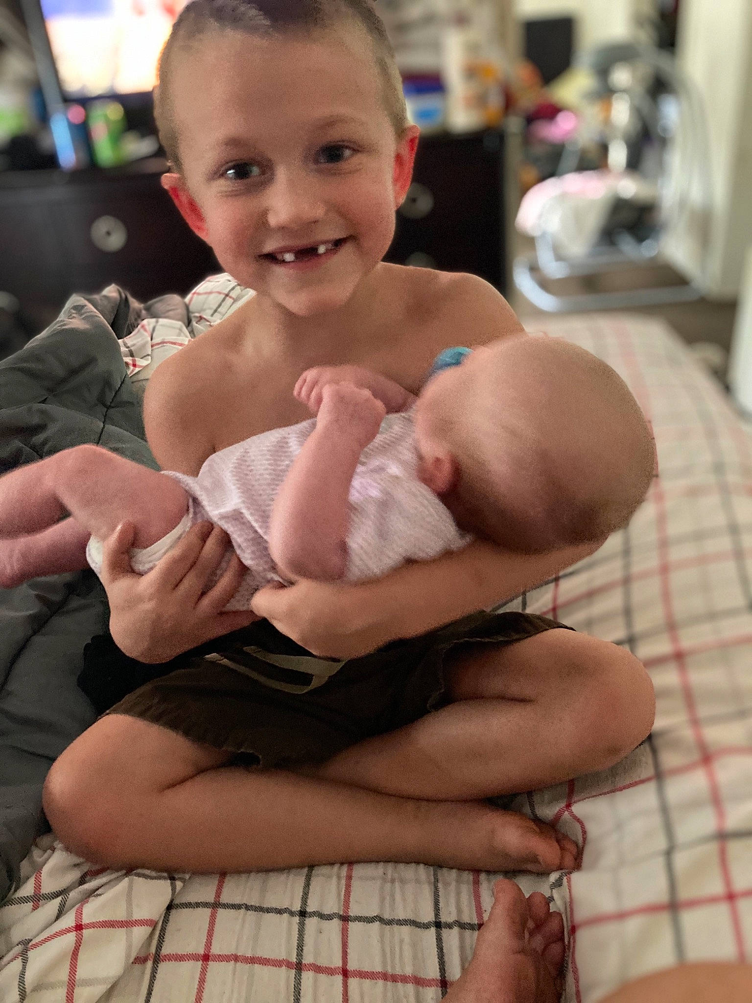 Aiden is registered to the contest to win money with this photo: baby, baby_toddler_clothing, cheek, child, comfort, face, gesture, hair, happy, head, joint, joy, leg, muscle, person, skin, smile, stomach, tartan, thigh