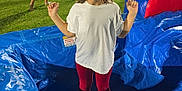 Avah joined the competition — help win amazing prizes! child, smiling, inflatable, playground, night, outdoor, event, people, crowd, food_truck, grass, blue, white_shirt, red_pants, fun, happy, festival, family, recreation, leisure