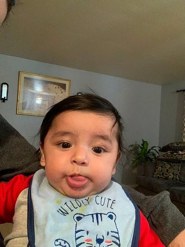 Kalei joined the competition — help win amazing prizes! baby, baby_toddler_clothing, black_hair, cheek, ear, eyebrow, eyelash, forehead, happy, houseplant, jaw, lip, nose, outerwear, person, picture_frame, plant, skin, sleeve, t_shirt