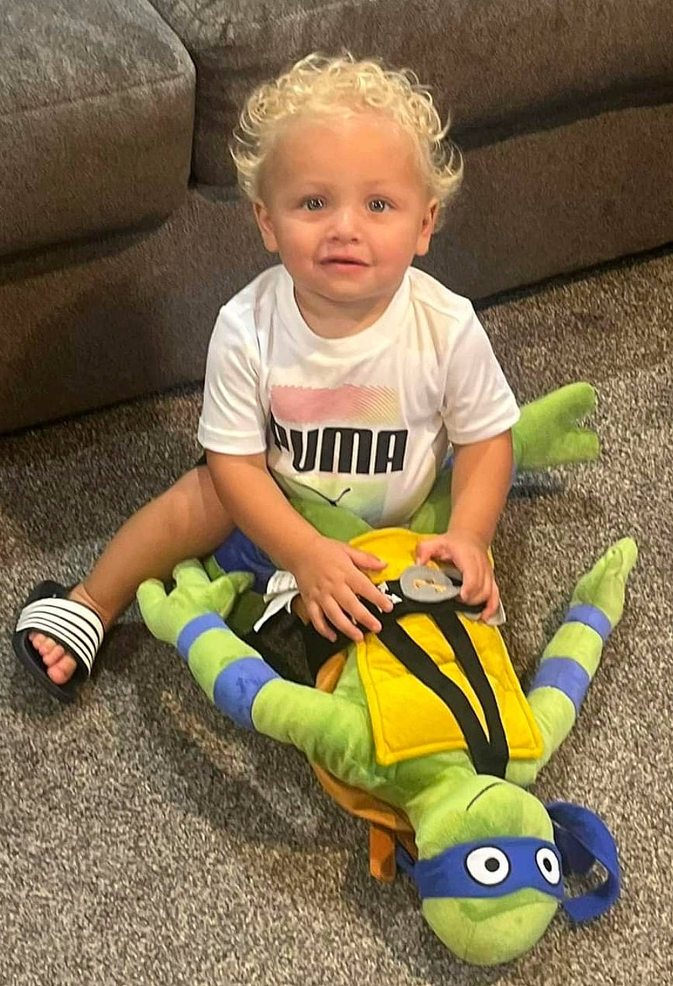 Rome is registered to the contest to win money with this photo: baby, baby_playing_with_toys, baby_products, baby_toddler_clothing, baby_toys, child, couch, face, fun, grass, happy, head, person, play, sitting, smile, snapshot, t_shirt, toddler, toy