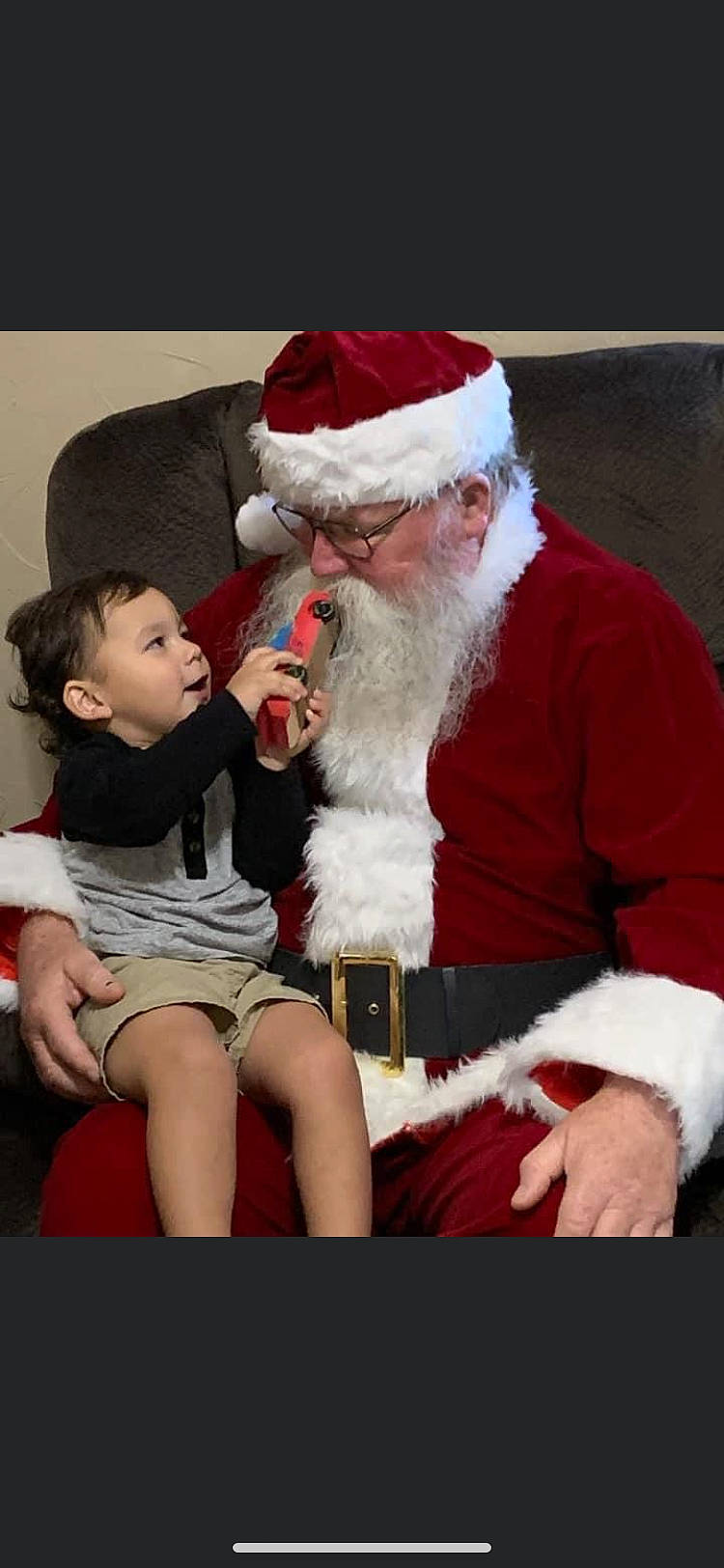 Kade joined the competition — help win amazing prizes! baby, beard, christmas, christmas_eve, comfort, costume_hat, event, face, facial_hair, fictional_character, fur, fur_clothing, happy, hat, holiday, lap, person, santa_claus, shorts, sitting