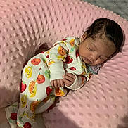 Ava joined the competition — help win amazing prizes! baby, sleeping, infant, onesie, fruit_pattern, pink_pillow, soft_texture, cozy, cute, hand, face, hair, pacifier, resting, indoors, closeup, child, newborn, comfort, blanket