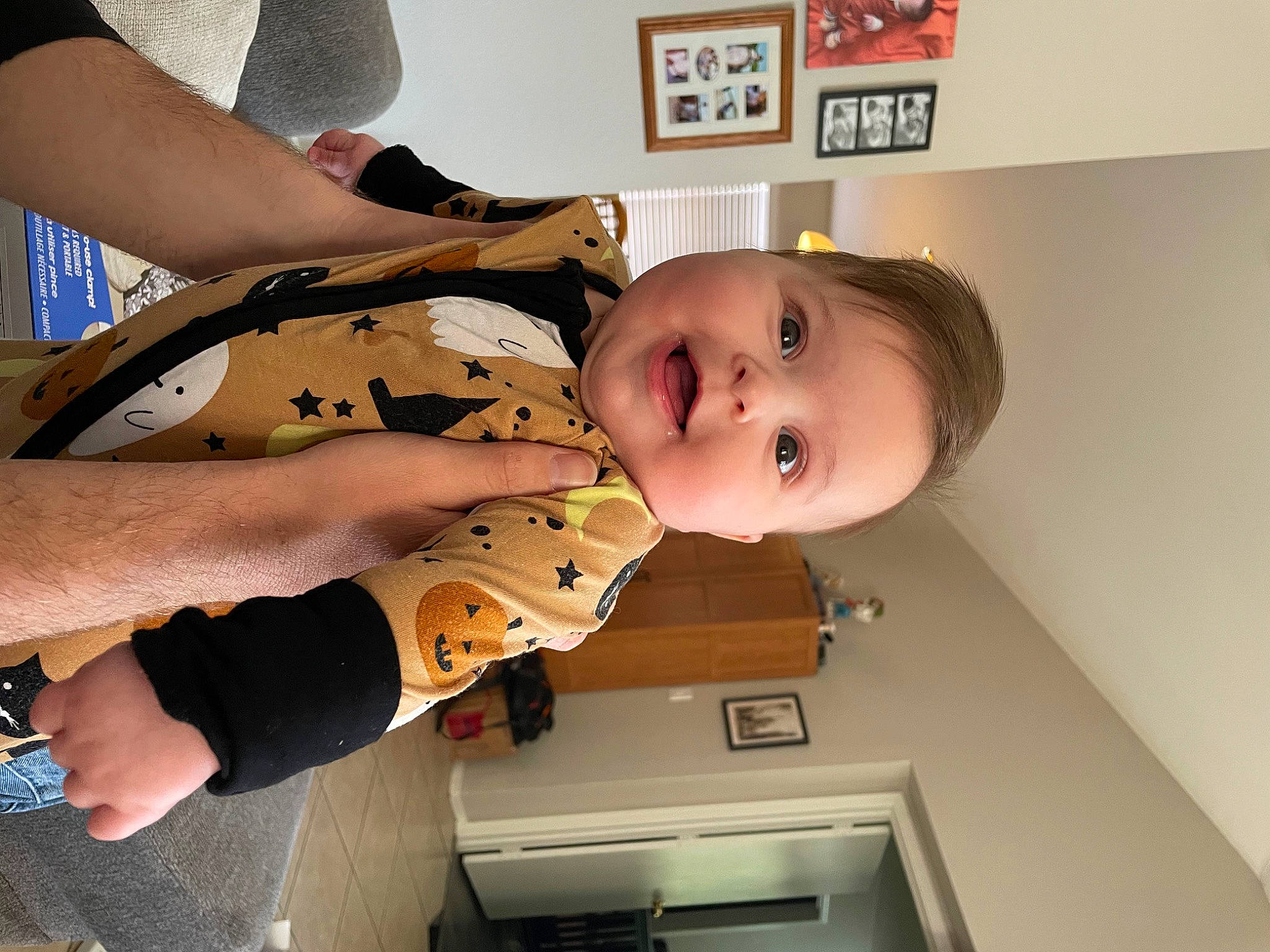 Clementine is registered to the contest to win money with this photo: arm, baby, baby_toddler_clothing, cheek, child, comfort, dress, elbow, eye, finger, happy, human_leg, joint, mouth, person, picture_frame, room, smile, thigh, toddler