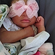 Sianni is registered to the contest to win money with this photo: baby, infant, sleeping, blanket, pacifier, bow, headband, clothing, face, hand, comfort, soft, cute, resting, indoors, child, newborn, peaceful, cozy, portrait