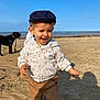 Gabin a rejoint le concours — aidez-le/la à gagner de superbes lots ! animal, beach, cap, child, dog, happy, hoodie, nature, outdoor, pants, person, play, sand, sea, shadow, sky, smile, sunlight, toddler, waves