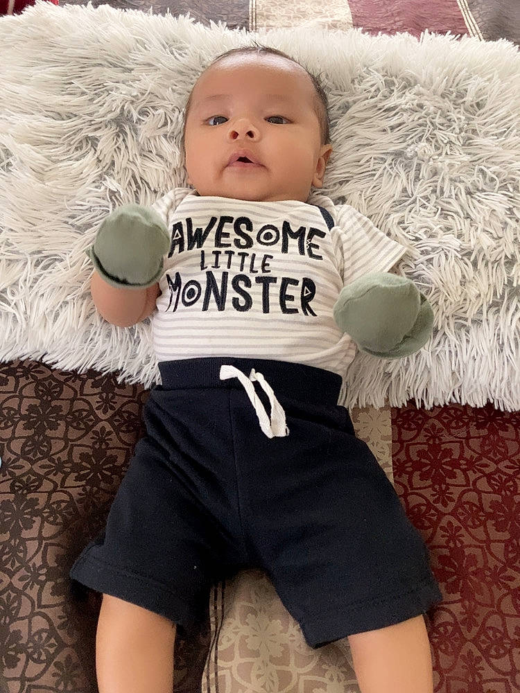 Mark is registered to the contest to win money with this photo: baby, baby_toddler_clothing, child, child_model, flash_photography, fur, gesture, happy, logo, pattern, person, personal_protective_equipment, photo_shoot, play, portrait_photography, sleeve, sportswear, t_shirt, textile, toddler