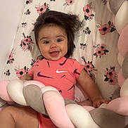 Duleivis joined the competition — help win amazing prizes! baby, smiling, infant, onesie, nike, pink, hair, cushion, braided, floral, blanket, happy, child, cute, playful, indoor, person, soft, pattern, lying