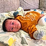 Daniel joined the competition — help win amazing prizes! baby, infant, child, lying_down, couch, blanket, mittens, socks, yellow_clothing, patterned_mat, indoor, cute, portrait, face, young_child, soft_toys, relaxed, home, comfort, resting