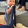 baby, child, dog, playpen, carpet, person, indoor, furniture, couch, curious, pet, home, floor, clothing, footwear, adult, seated, blond_hair, young_child, domestic