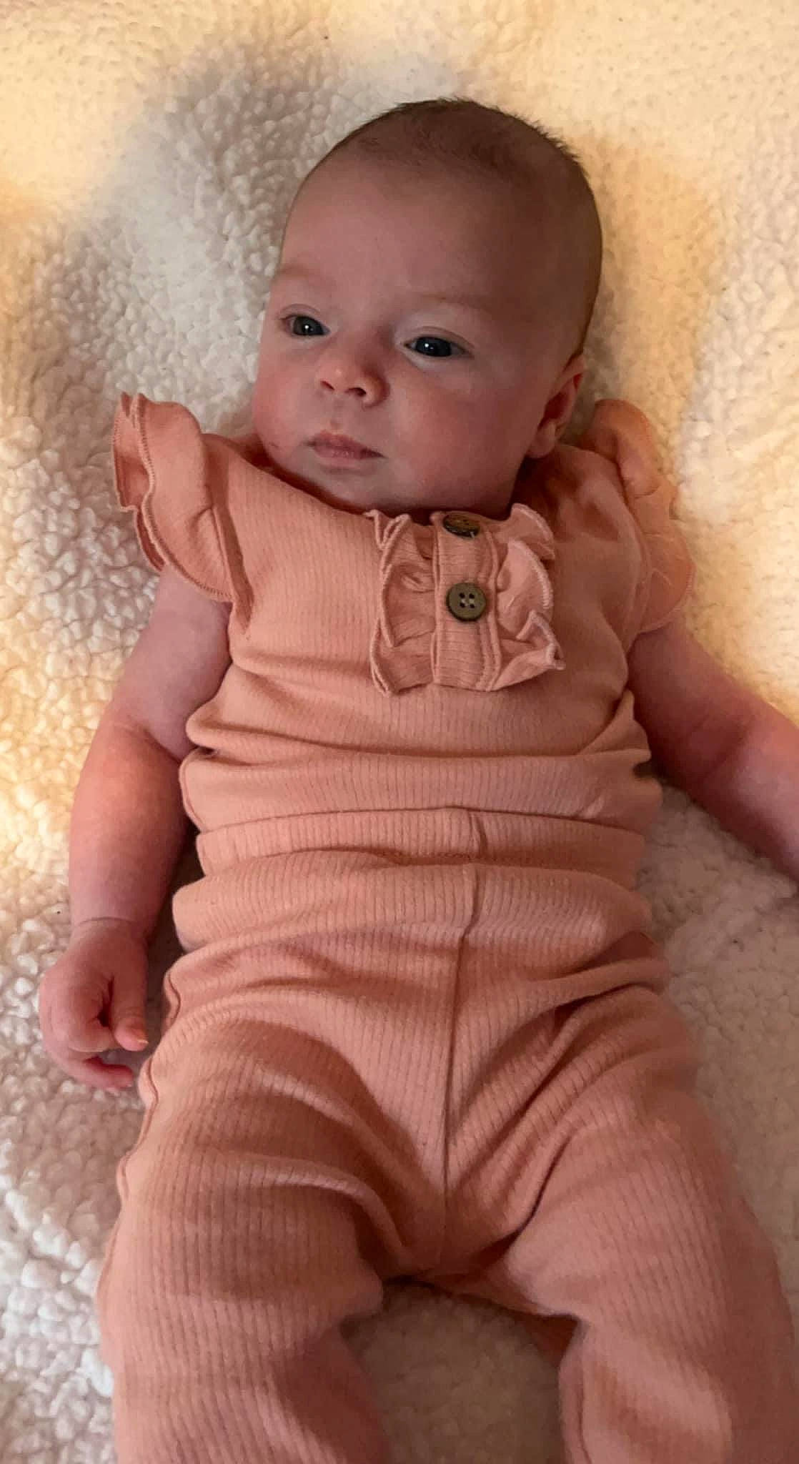 Estella joined the competition — help win amazing prizes! arm, baby, baby_toddler_clothing, cheek, chin, dress, eye, eyebrow, face, hand, head, iris, lip, neck, nose, person, pink, shoulder, skin, sleeve