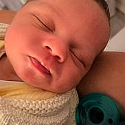 Darvy Domingos Veiga is registered to the contest to win money with this photo: adorable, arm, baby, blanket, close_up, closed_eyes, cozy, face, indoor, infant, knitted_clothing, newborn, nursery, pacifier, parent, photography, portrait, resting, sleeping, soft_lighting