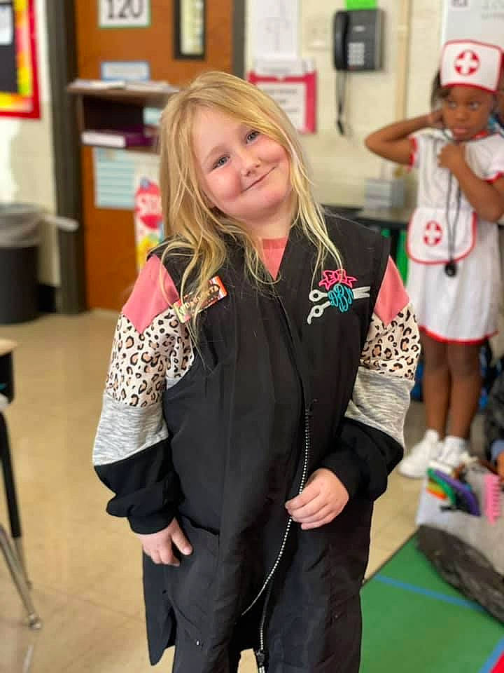 Paisleigh is registered to the contest to win money with this photo: blazer, cap, child, community, event, fashion_accessory, fashion_design, flooring, formal_wear, fun, hairstyle, hat, head, headwear, jewellery, joint, joy, necklace, person, smile