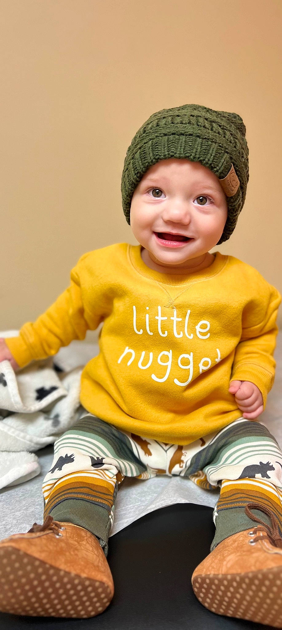 Blaze is registered to the contest to win money with this photo: baby_toddler_clothing, cap, chair, cheek, eye, face, facial_expression, green, hand, happy, headwear, human, human_body, joy, membranophone, organ, outerwear, person, skin, sleeve