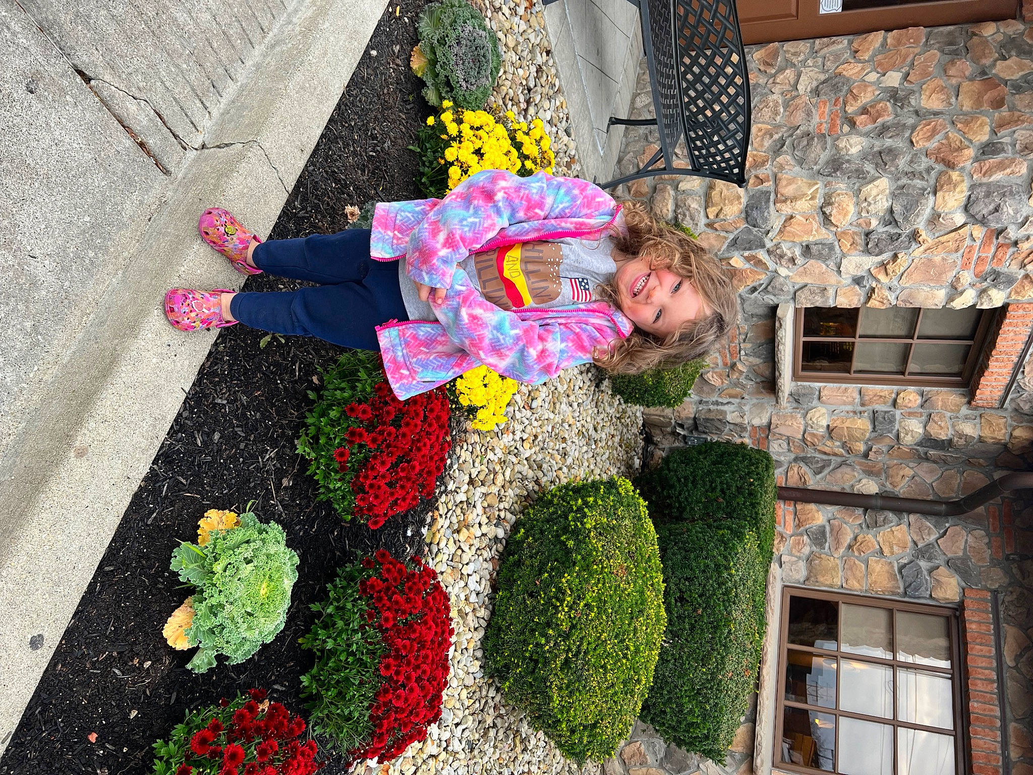 Piper is registered to the contest to win money with this photo: annual_plant, asphalt, building, cut_flowers, facade, floral_design, flower, flower_arranging, hedge, house, joy, leisure, pattern, person, petal, plant, road_surface, shrub, sidewalk, street