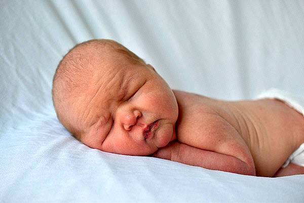 Kolby is registered to the contest to win money with this photo: baby, bedtime, cheek, child, childbirth, comfort, event, eyebrow, flesh, human_body, linens, neck, nose, person, portrait_photography, room, service, skin, sleep, sorrow