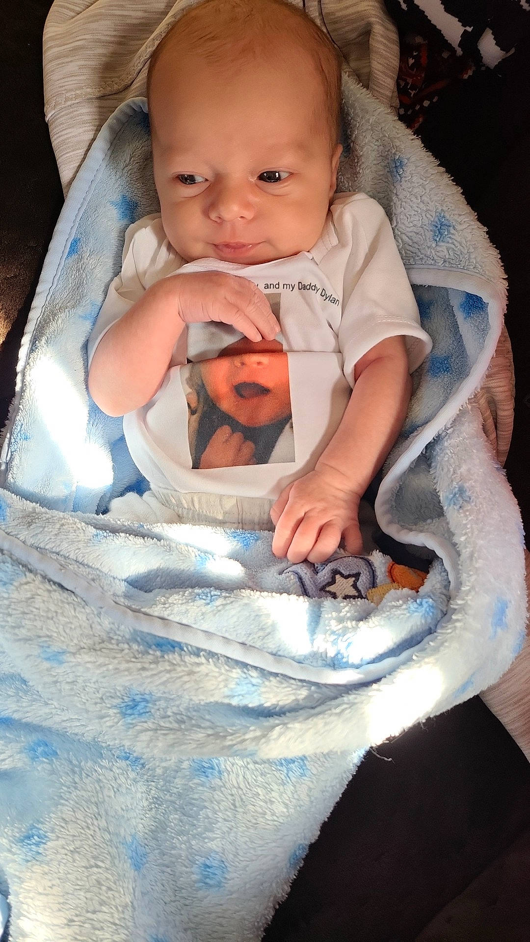 Greyson joined the competition — help win amazing prizes! baby, baby_carriage, baby_products, baby_toddler_clothing, blue, cheek, child, comfort, eye, gesture, happy, iris, linens, nail, person, sitting, skin, sleeve, smile, thumb