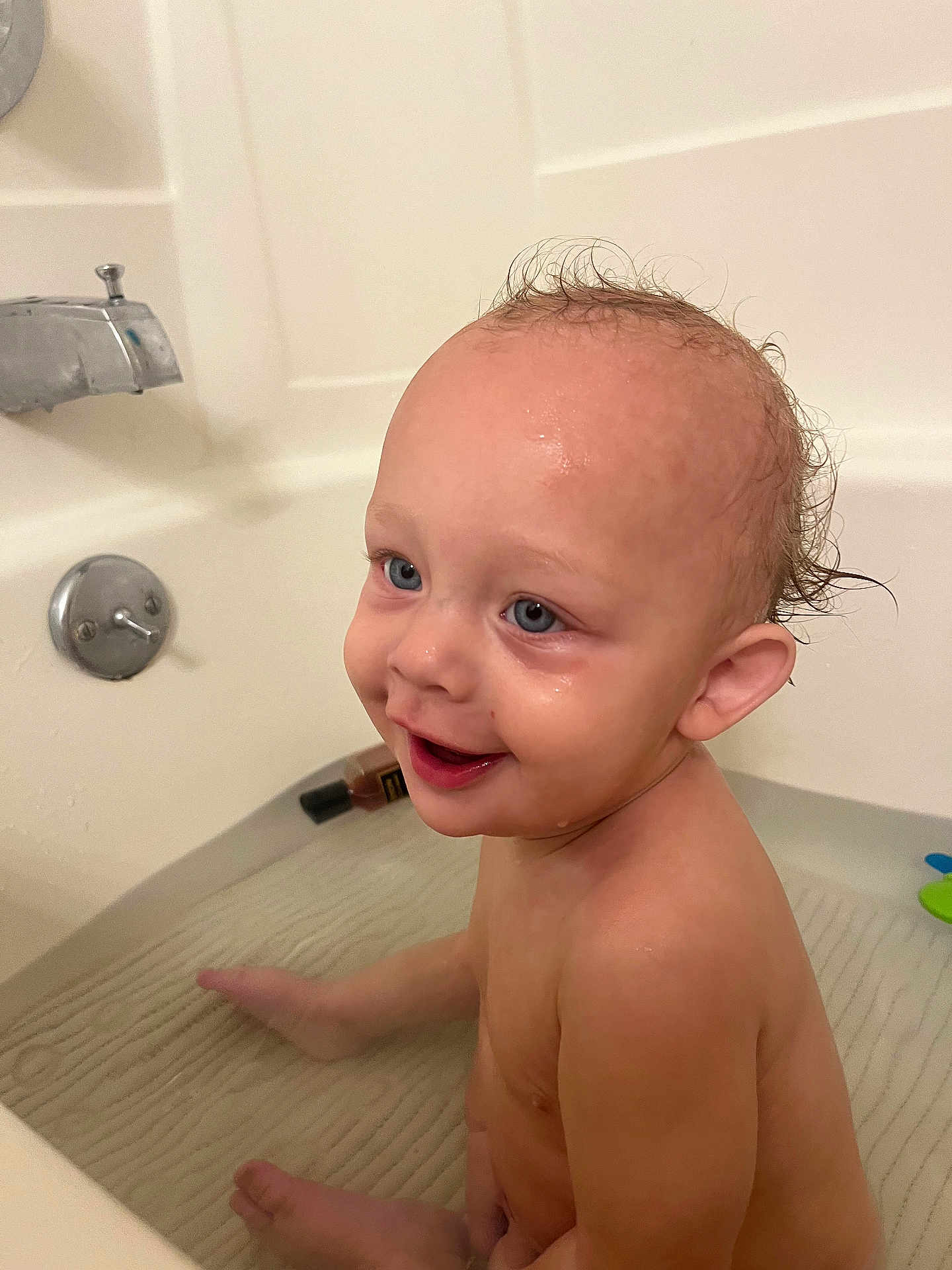 Silas is registered to the contest to win money with this photo: toddler, child, bath, bathtub, water, smile, wet_hair, happy, skin, face, ear, sitting, bathroom, plumbing_fixture, toy, infant, person, cute, playful, cleaning