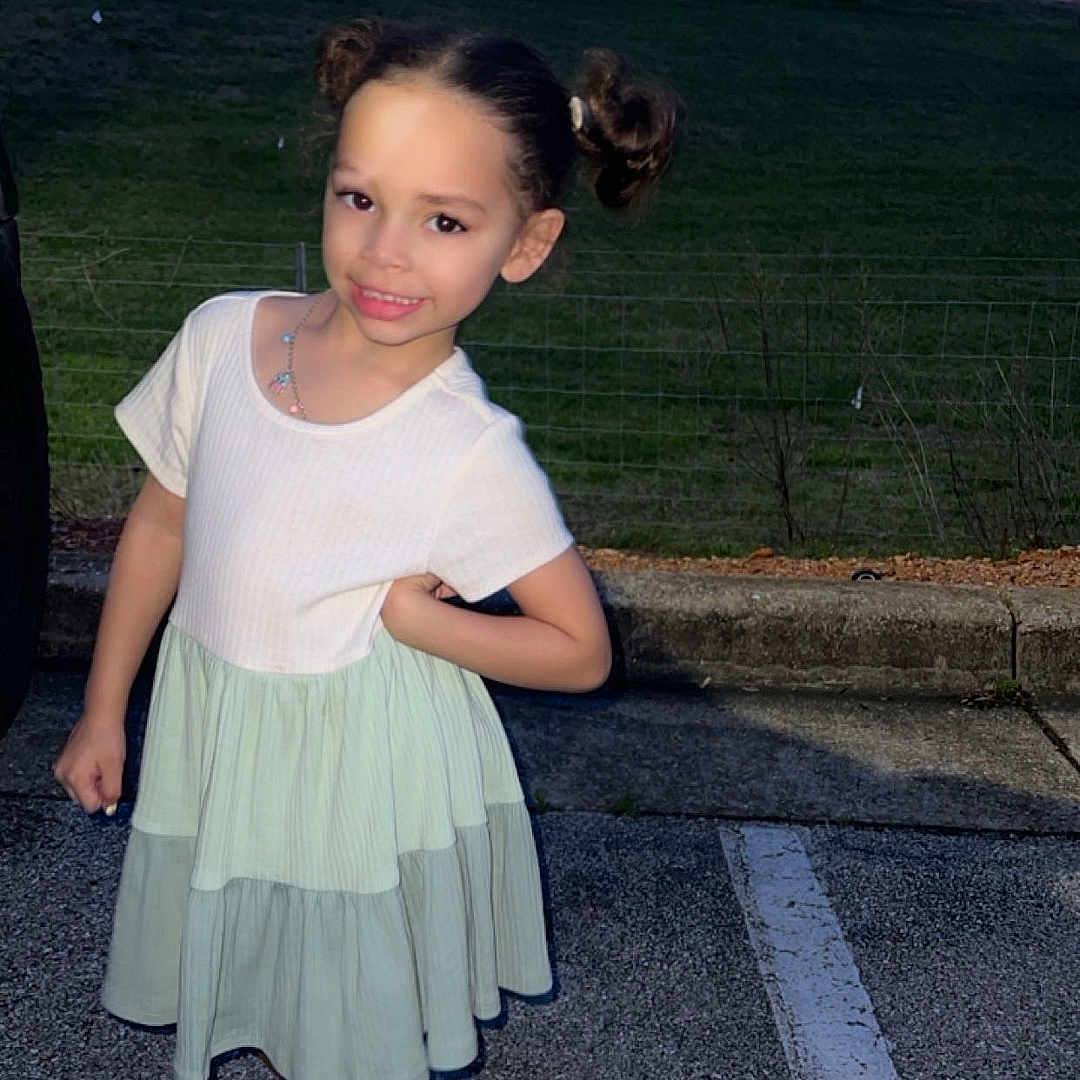 Zariah joined the competition — help win amazing prizes! child, city, clothing, dress, face, female, footwear, girl, grass, head, person, photography, pickuptruck, plant, portrait, road, sandal, shoe, skirt, transportation