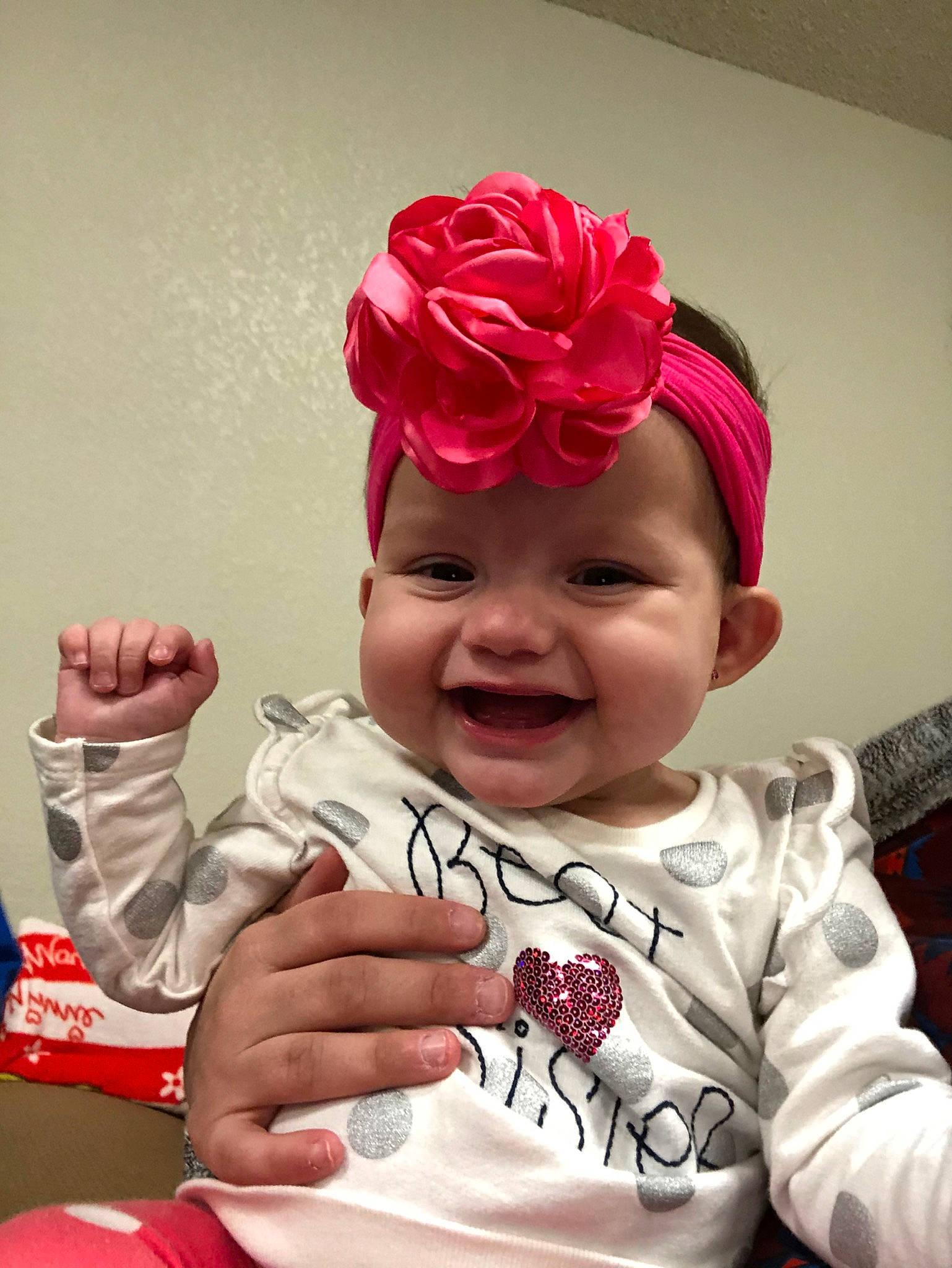 Jazmyn is registered to the contest to win money with this photo: baby, cheek, child, fashion_accessory, finger, flower, forehead, hair_accessory, hand, happy, head, headband, headgear, headpiece, joy, person, petal, pink, plant, red