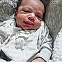 Ronen is registered to the contest to win money with this photo: baby, newborn, smile, face, infant, clothing, striped, blanket, soft, cozy, person, cute, portrait, hand, sleepwear, indoors, resting, child, young, head