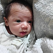 Ronen is registered to the contest to win money with this photo: baby, newborn, infant, face, blanket, cushion, closeup, sleepwear, resting, soft, cozy, portrait, child, indoors, expression, curious, small, human, skin, head