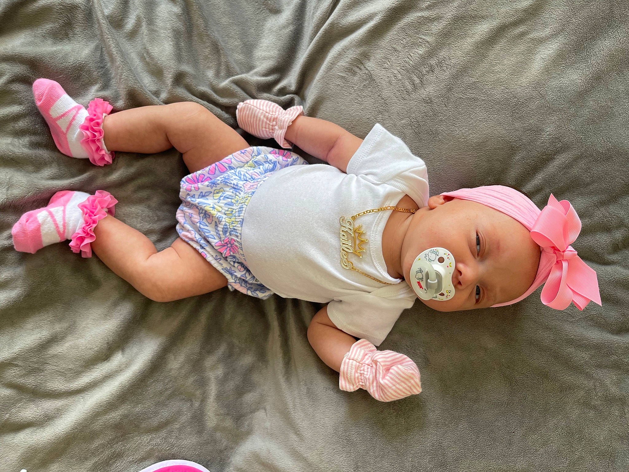 Kailee is registered to the contest to win money with this photo: arm, baby, baby_toddler_clothing, comfort, doll, dress, finger, glasses, hand, hat, head, headgear, human_body, leg, person, pink, skin, sleeve, sunglasses, thigh