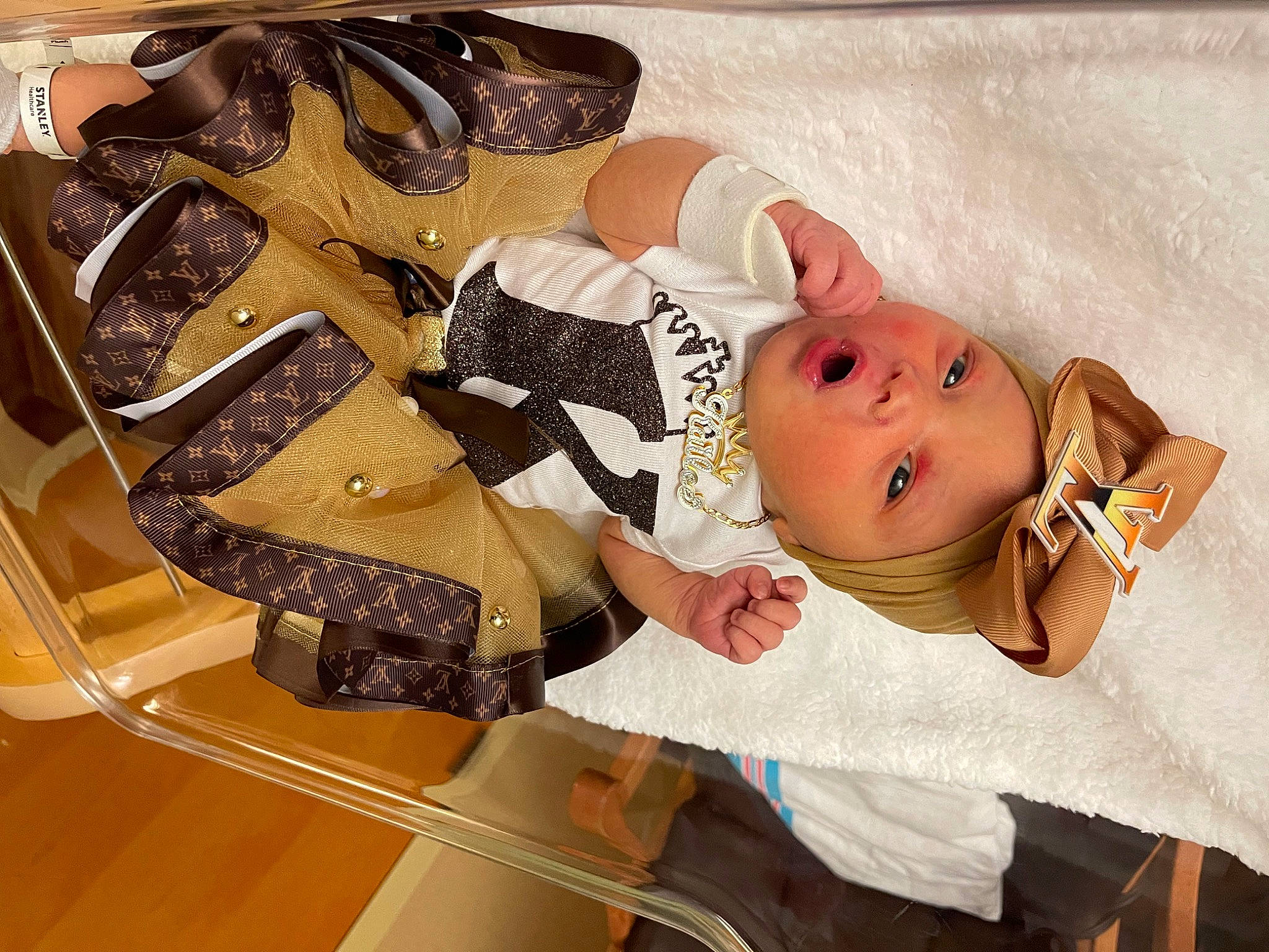 Kailee joined the competition — help win amazing prizes! baby, baby_products, baby_safety, baby_toddler_clothing, carmine, child, comfort, fashion_accessory, hair_accessory, happy, hat, headwear, pattern, person, room, rose, sandal, smile, toddler, wood