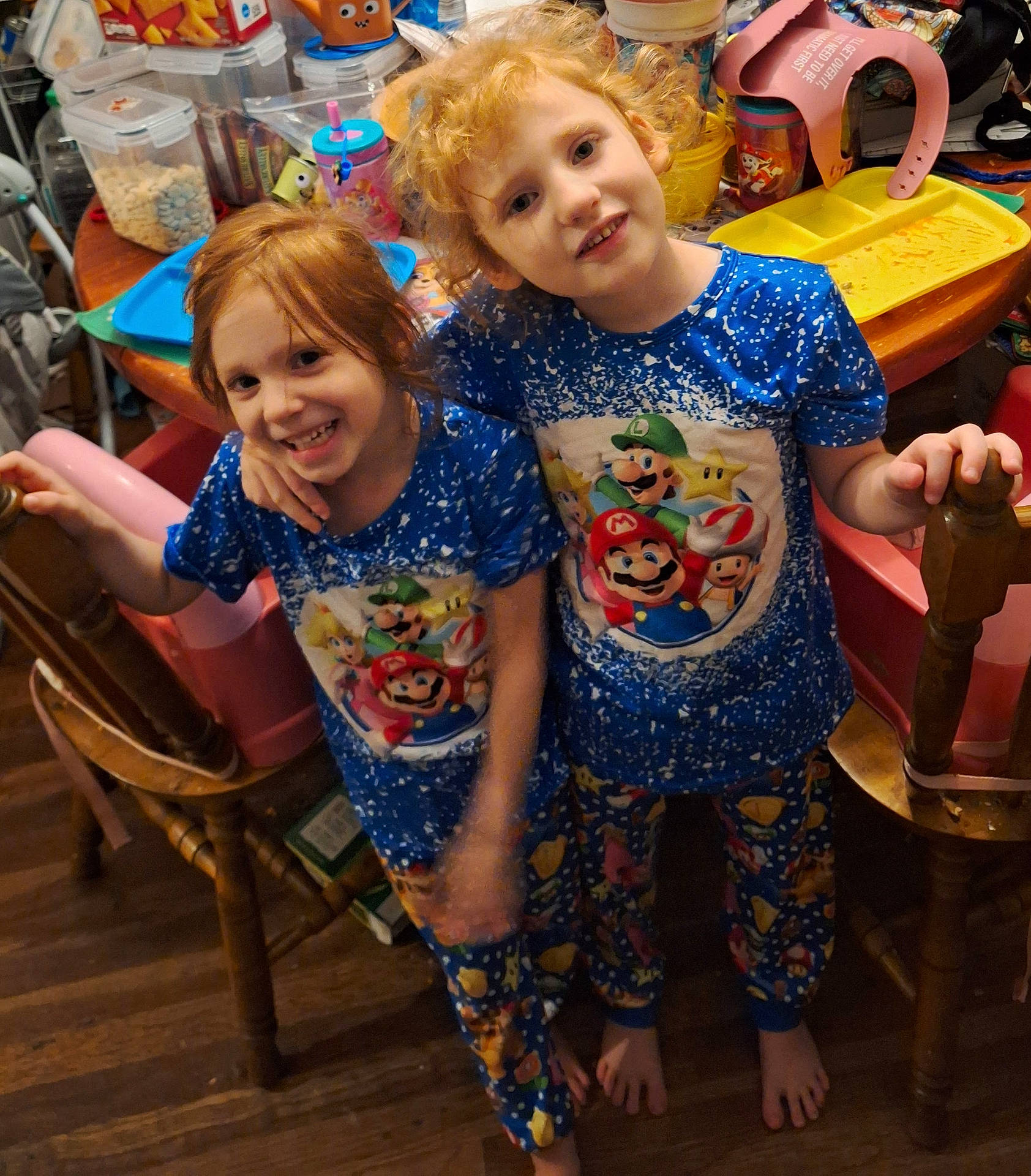 Rachel And Kayla is registered to the contest to win money with this photo: baby, chair, child, clothing, diningtable, dress, face, female, furniture, girl, head, indoors, pajamas, pants, person, photography, portrait, t_shirt, table, wood