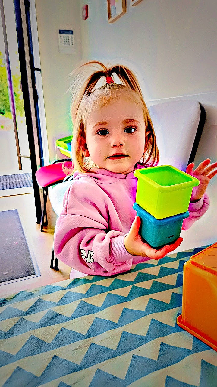 Kenza a rejoint le concours — aidez-le/la à gagner de superbes lots ! baby, baby_playing_with_toys, baby_toddler_clothing, child, flooring, fun, happy, leisure, magenta, pattern, person, pink, plant, play, portrait_photography, room, sitting, smile, toddler, toy