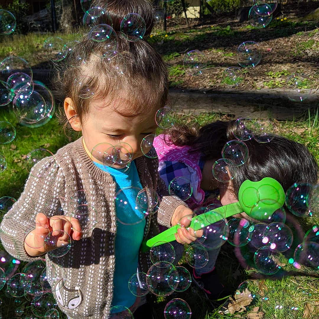 Aria is registered to the contest to win money with this photo: adaptation, child, fun, grass, green, happy, leaf, liquid_bubble, person, plant, play, smile, spring, summer, toddler, tree, water