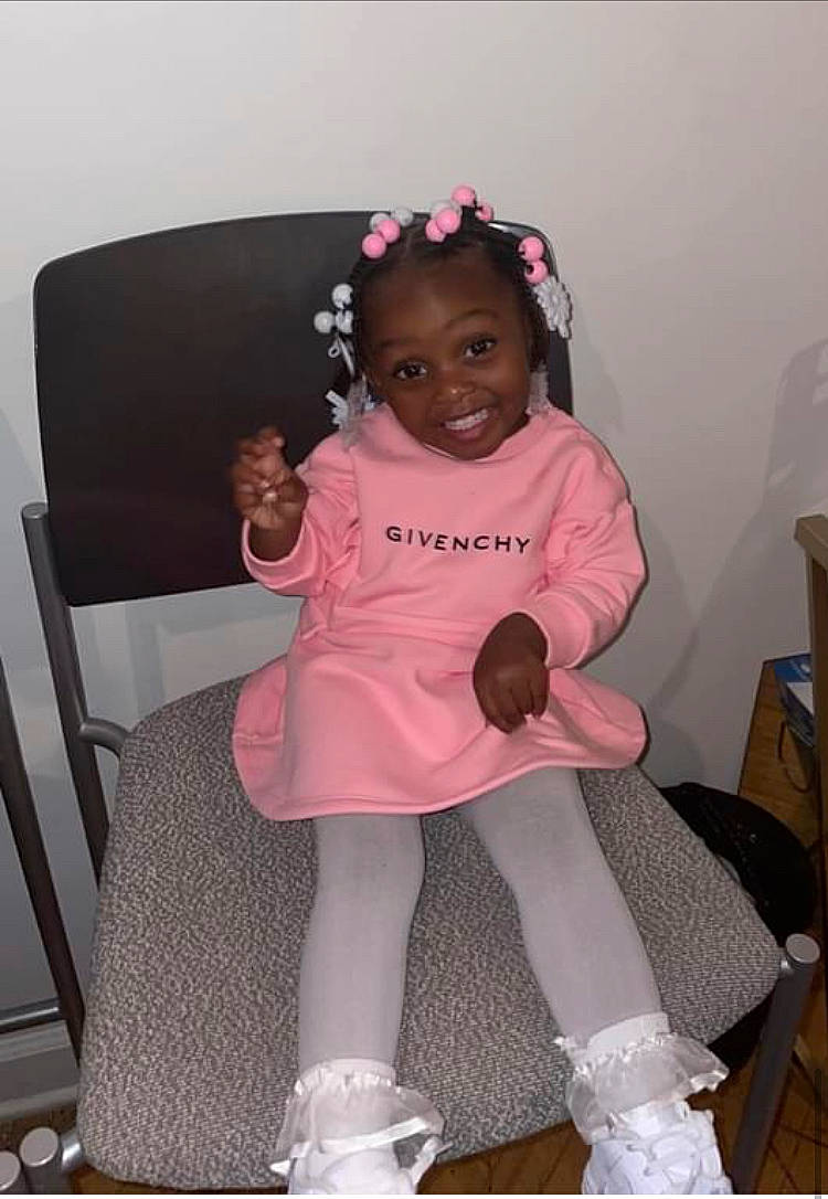 Serenity is registered to the contest to win money with this photo: baby_toddler_clothing, chair, child, comfort, dress, embellishment, event, fashion_accessory, fun, happy, human_leg, joy, knee, magenta, person, pink, sitting, sleeve, smile, sock