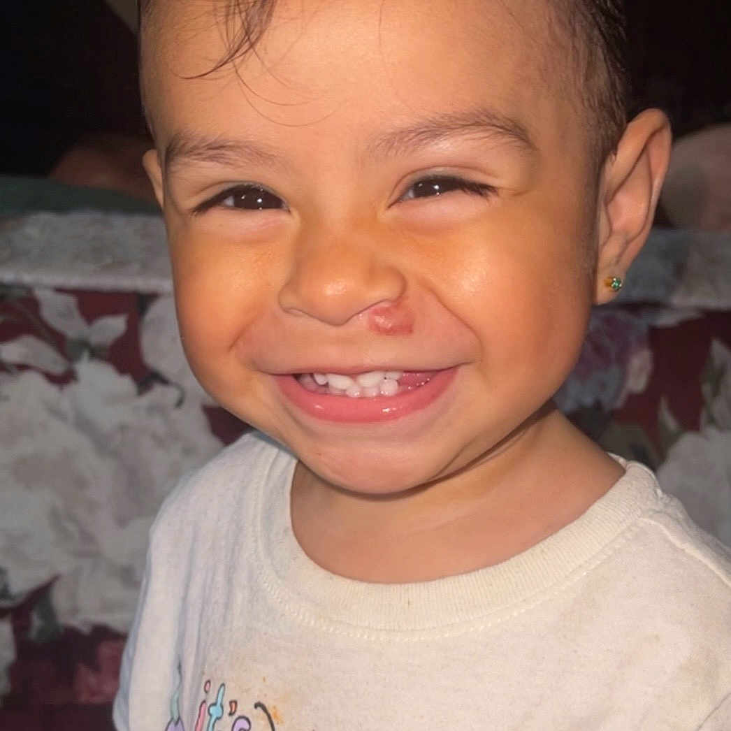 Aelyn is registered to the contest to win money with this photo: baby, child, clothing, cute, earring, expression, face, hair, happy, indoors, joy, person, portrait, shirt, sitting, skin, smiling, teeth, toddler, young