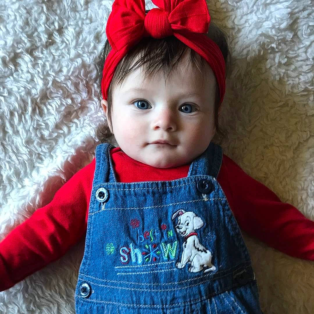 Milli is registered to the contest to win money with this photo: baby, baby_toddler_clothing, child, clothing, ear, fashion_accessory, fur, hair_accessory, head, headgear, knit_cap, outerwear, pattern, person, red, sleeve, textile, toddler, wool, woolen