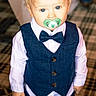 toddler, child, pacifier, vest, bowtie, blue_eyes, blond_hair, shirt, formal_wear, indoor, carpet, portrait, cute, standing, person, young_child, fashion, baby, face, clothing