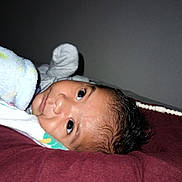 Gael is registered to the contest to win money with this photo: baby, blanket, pillow, pacifier, indoor, resting, curious, child, infant, soft, sleepy, lying_down, face, young, cozy, wrapped, cute, person, bed, comfort
