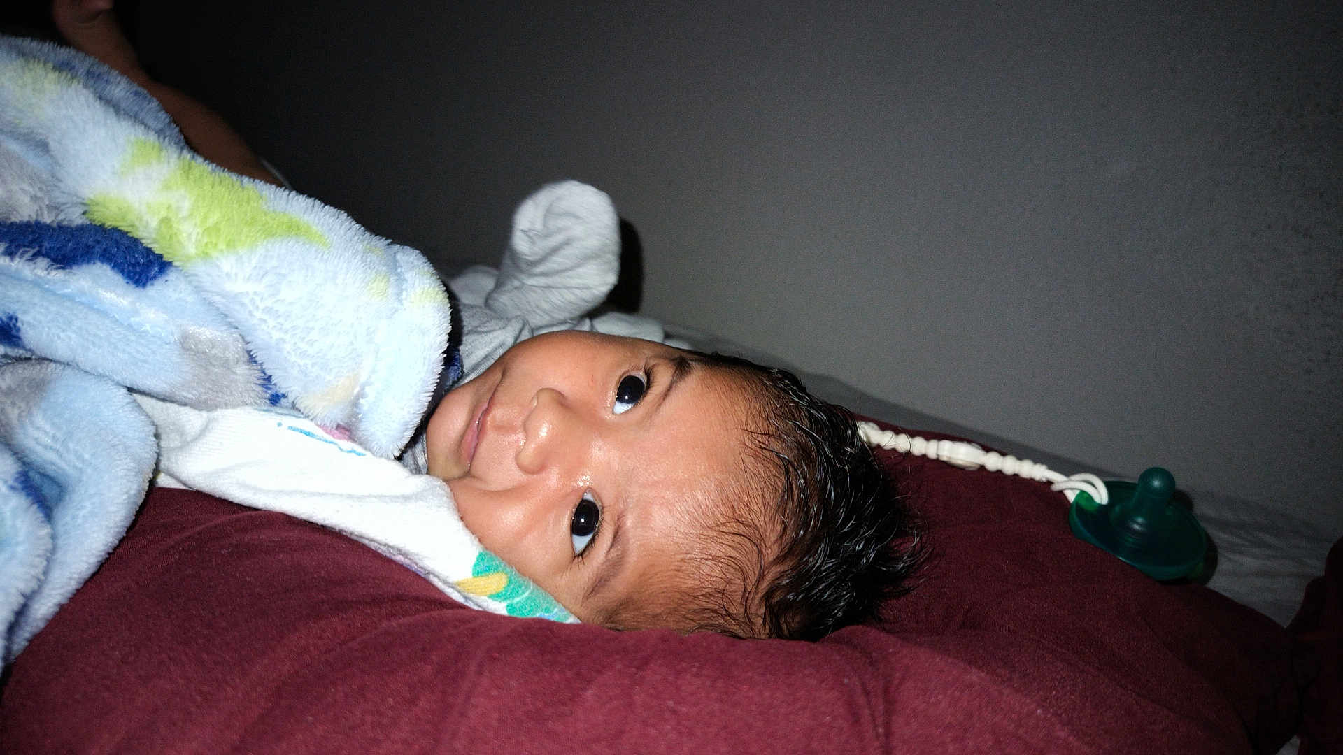 Gael is registered to the contest to win money with this photo: baby, blanket, pillow, pacifier, indoor, resting, curious, child, infant, soft, sleepy, lying_down, face, young, cozy, wrapped, cute, person, bed, comfort