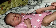 Journey is registered to the contest to win money with this photo: baby, newborn, sleeping, blanket, pink, polka_dot, infant, clothing, cute, toddler, skin, hand, foot, soft, cozy, rest, child, face, peaceful, wrapped