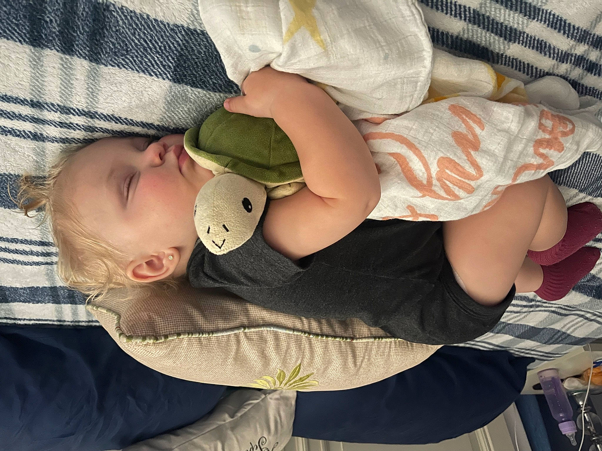 Mckenzie is registered to the contest to win money with this photo: arm, baby, baby_products, baby_sleeping, baby_toddler_clothing, cheek, child, comfort, finger, foot, gesture, hand, human_body, nail, pattern, person, sitting, skin, sleeve, thumb