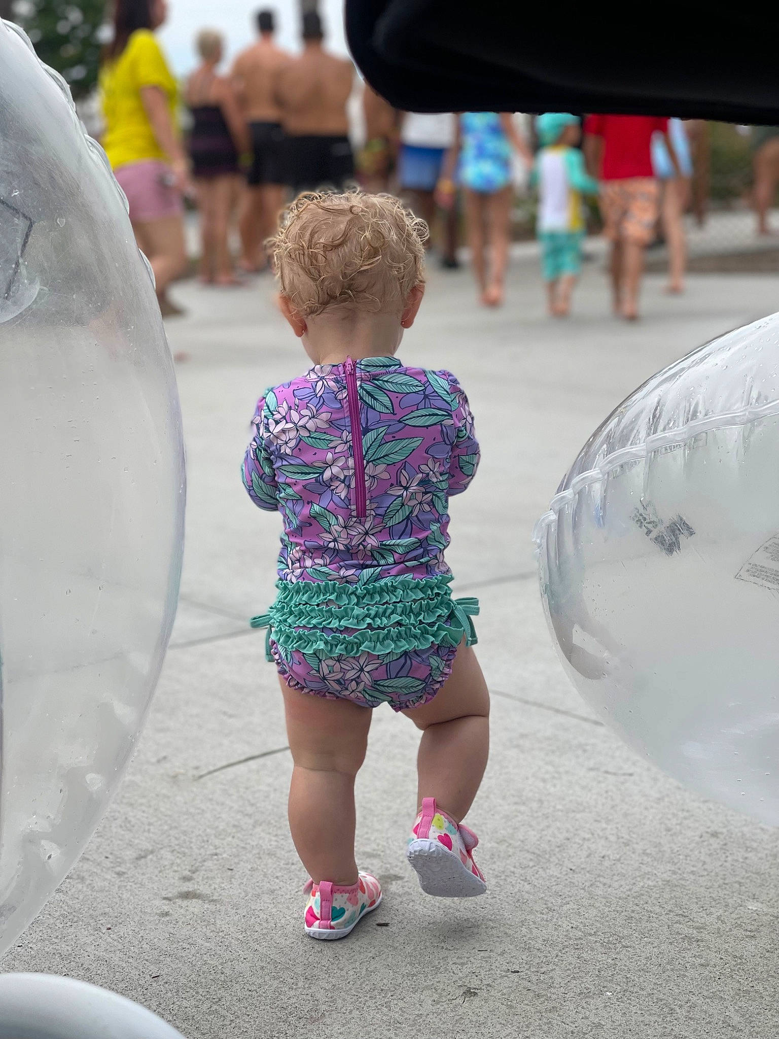Mckenzie is registered to the contest to win money with this photo: child, city, daytime, event, fountain, fun, hairstyle, happy, human_leg, leisure, pedestrian, person, pink, recreation, shorts, standing, t_shirt, thigh, toddler, white