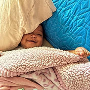 Tiana is registered to the contest to win money with this photo: baby, blanket, bottle, child, cozy, fabric, face, hand, infant, lying_down, pink, blue, smiling, soft_texture, snuggled, toddler, warm, young_child, bed, comfort