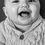 baby, infant, smiling, face, knitted_sweater, child, portrait, cute, happy, closeup, buttoned_sweater, young_child, black_and_white, eyelashes, chubby_cheeks, clothing, person, indoors, cute_expression, small_teeth