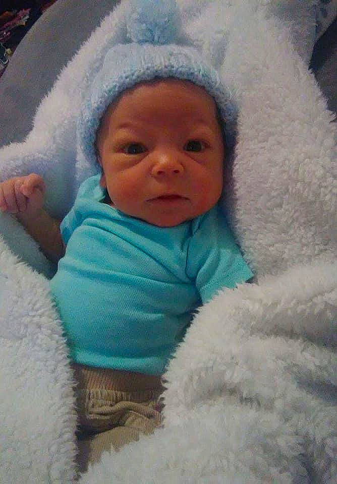 Jalen is registered to the contest to win money with this photo: baby, cheek, child, eye, eyebrow, face, fur, head, headwear, mouth, nose, person, skin, toddler, wool